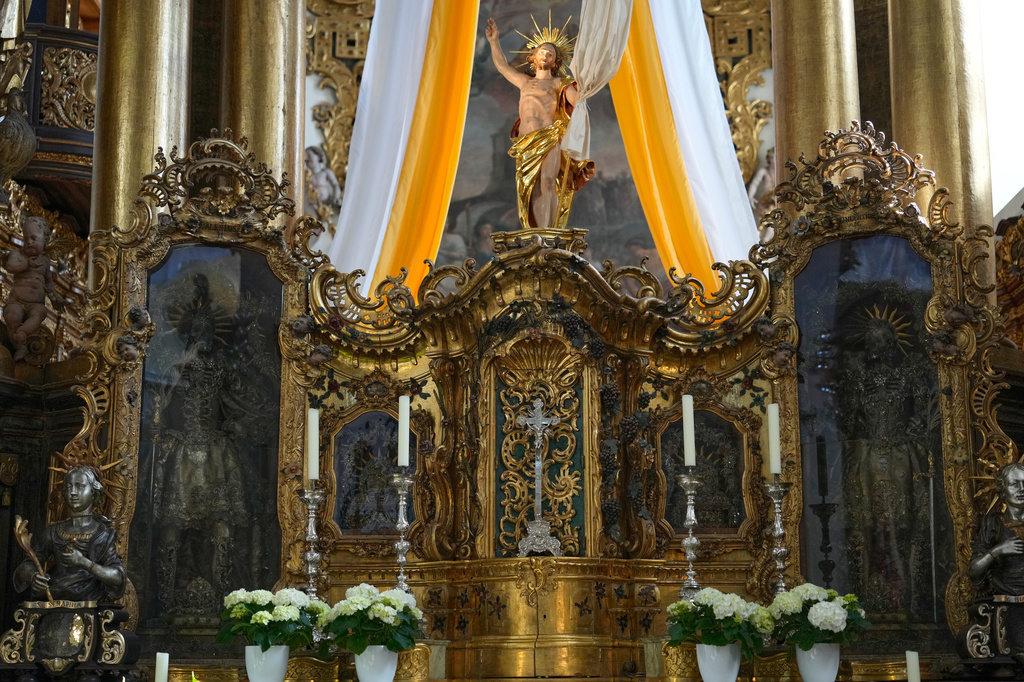 An elaborately decorated skeleton lies in the catholic monastery church of Banz in Bad Staffelstein, Germany, Saturday, May 2, 2026. (AP Photo/Matthias Schrader)
