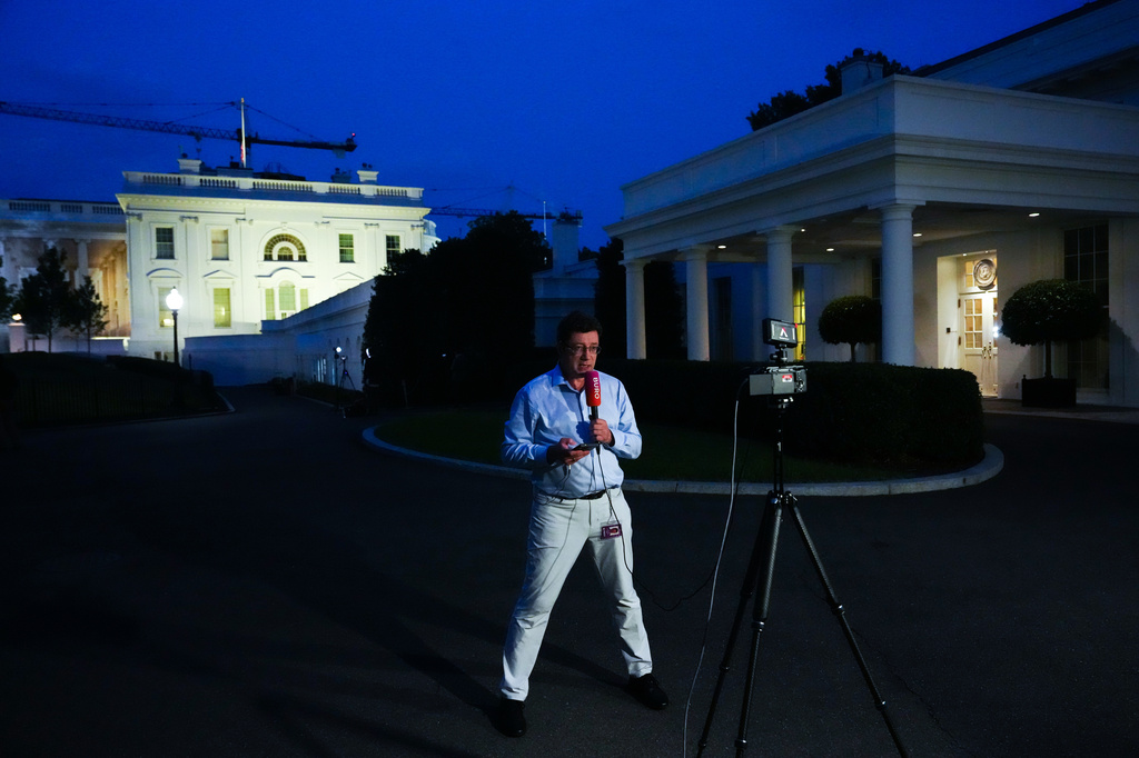 A reporter from Buro, a Russian-language YouTube channel, films a video in front of the White House as President Donald Trump speaks in the East Room, Thursday, July 16, 2026, in Washington. (AP Photo/Julia Demaree Nikhinson)