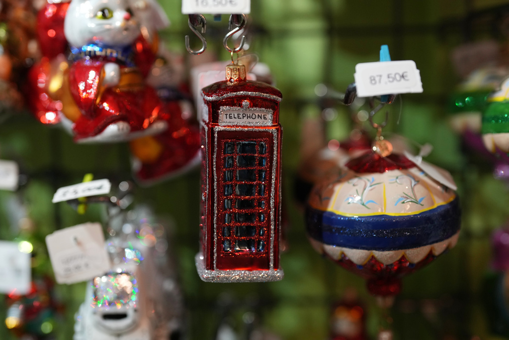 A holiday ornament of a British phone cabin hangs on a shelf in the Christel Dauwe Collection ornaments shop in Antwerp, Belgium, Monday, Dec. 8, 2025. (AP Photo/Virginia Mayo)