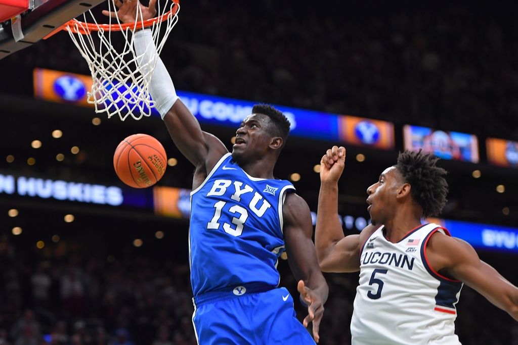 BYU center Keba Keita (13) takes a shot at the basket as UConn forward Tarris Reed Jr. (5) defends in the first half of an NCAA college basketball game, Saturday, Nov. 15, 2025, in Boston. (AP Photo/Steven Senne)