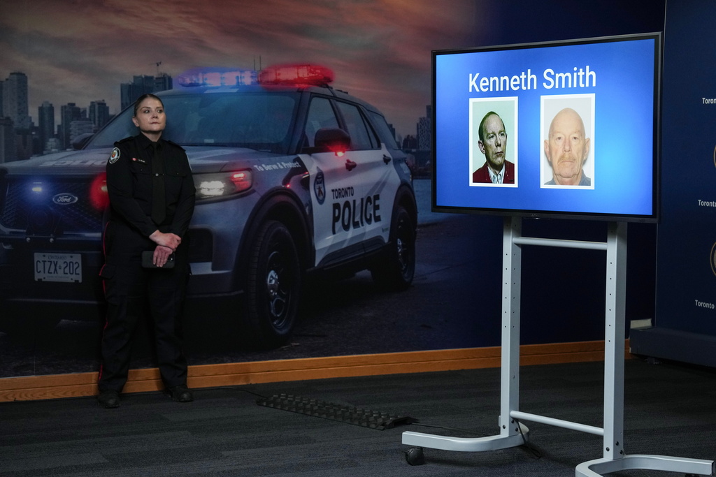 Images of Kenneth Smith are displayed as police provide a development in three historical homicide investigations, Thursday, Dec. 11, 2025, during a news conference at police headquarters in Toronto. (Chris Young/The Canadian Press via AP)