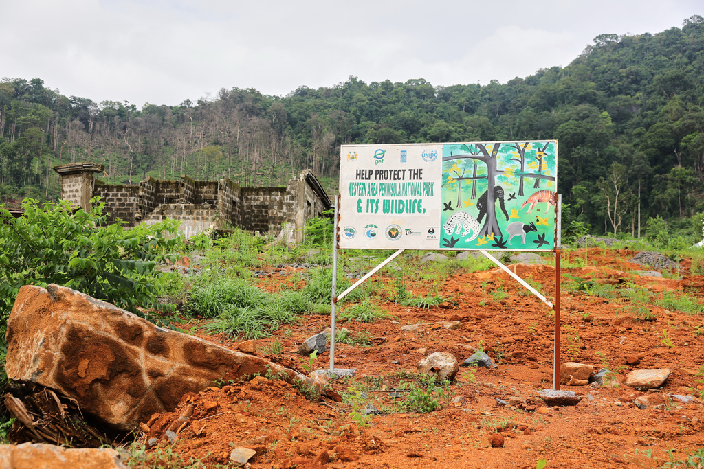 A sign urging protection of the Western Area Peninsula National Park, Sierra Leone, Saturday, July 5, 2025. (AP Photo/Misper Apawu)