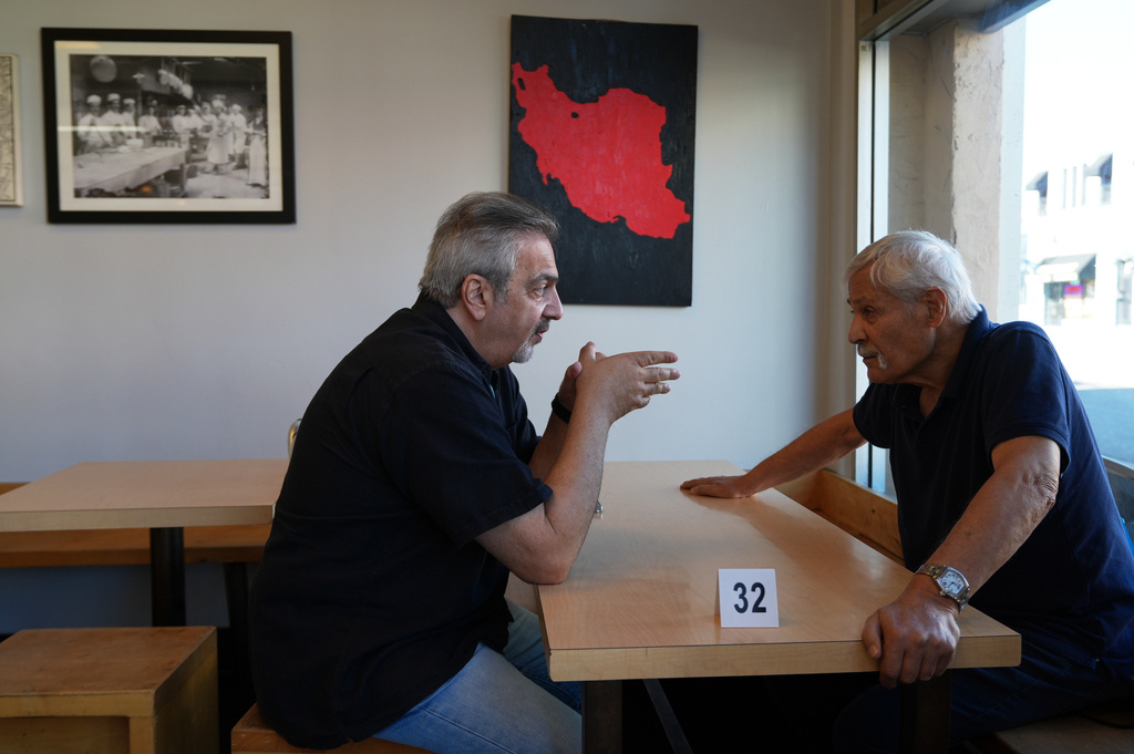 Customers talk inside the Taste of Tehran restaurant at the area known Little Tehran" or "Tehrangeles," the heart of the largest Iranian diaspora community in the United States, in Los Angeles, Monday, March 2, 2026. (AP Photo/Damian Dovarganes)