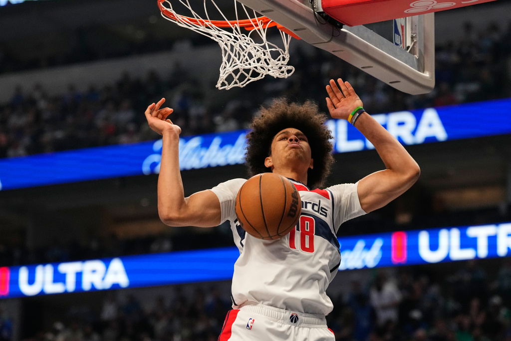 Washington Wizards forward Kyshawn George dunks in the first half of an NBA basketball game against the Dallas Mavericks, Friday, Oct. 24, 2025, in Dallas. (AP Photo/Tony Gutierrez)