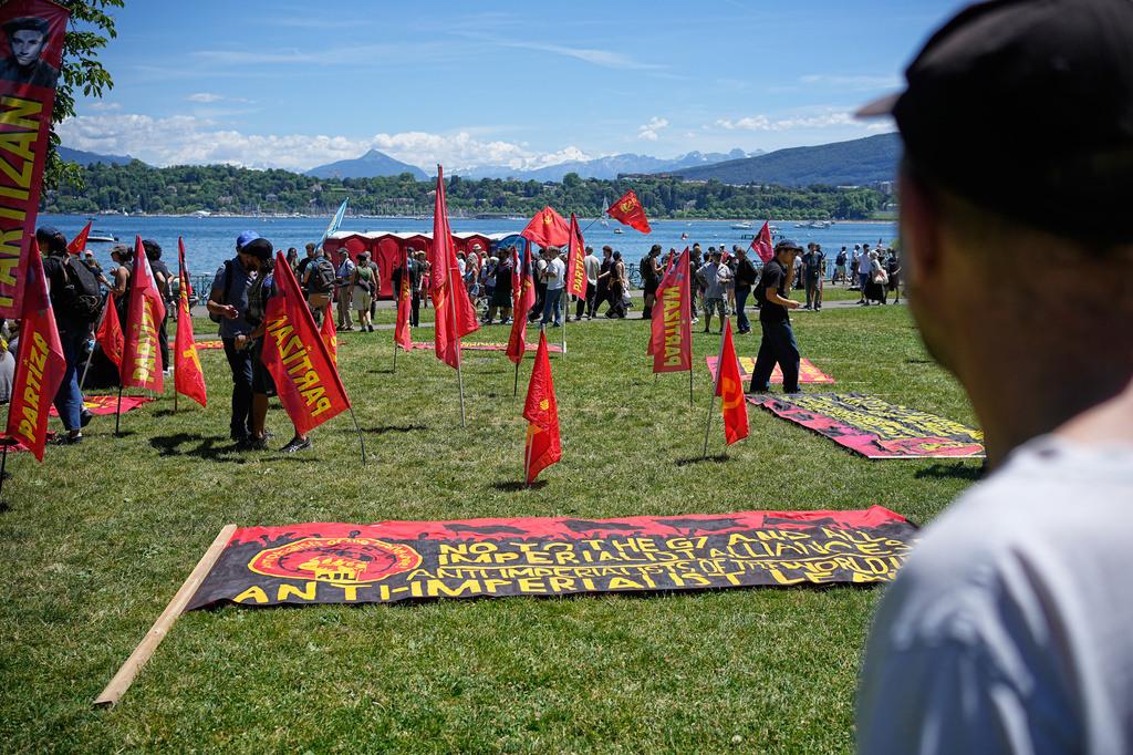 Protestors begin to gather in Geneva, Switzerland, with banners and signs during a demonstration, Sunday, June 14, 2026, ahead of the G7 summit scheduled to take place in France June 15-17. (AP Photo/Laurent Cipriani)