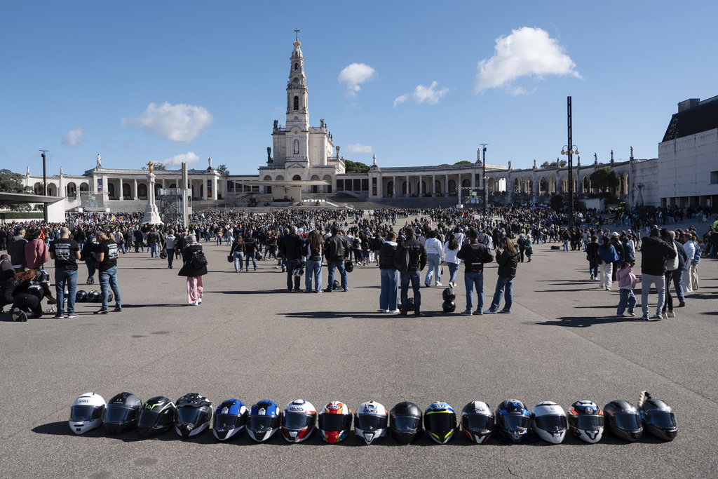 Helmets lie on the ground at the Roman Catholic holy shrine of Fatima, as motorcyclists arrive to have their helmets blessed during the 10th Pilgrimage of the Blessing of Helmets that draws tens of thousands, in Fatima, Portugal, Sunday, Sept. 21, 2025. (AP Photo/Ana Brigida)