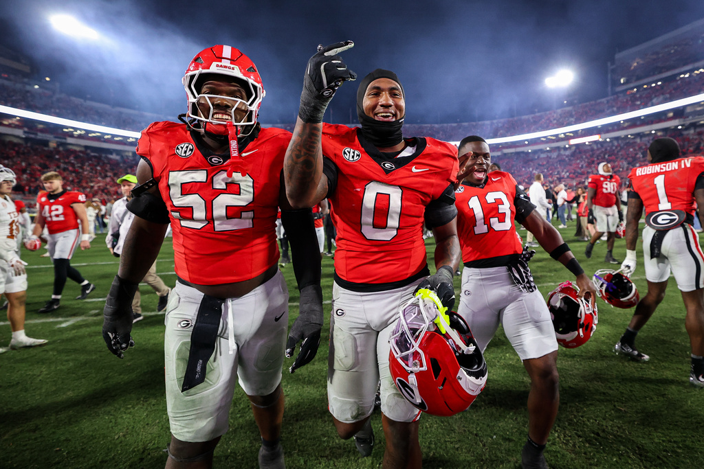 Georgia defensive lineman Christen Miller (52) and linebacker Gabe Harris Jr. (0) react after an NCAA college football game against Texas, Saturday, Nov. 15, 2025, in Athens, Ga. (AP Photo/Colin Hubbard)