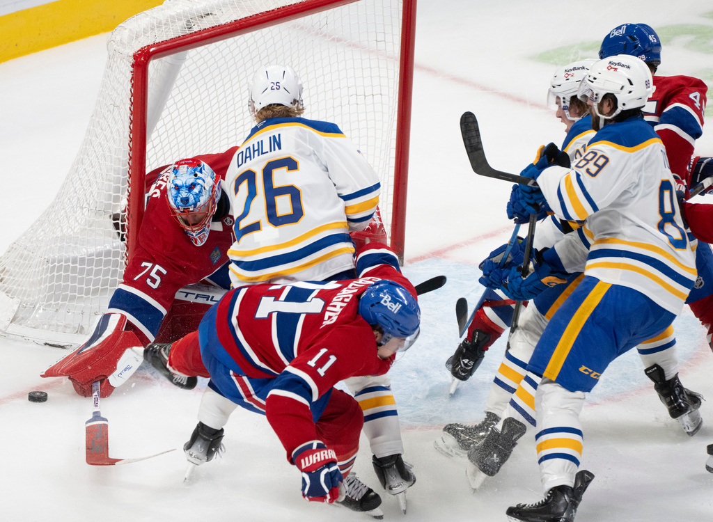 Montreal Canadiens goaltender Jakub Dobes (75) makes a save as Buffalo Sabres' Rasmus Dahlin (26) and Canadiens' Brendan Gallagher (11) look for the rebound during second period NHL hockey action in Montreal on Monday, Oct. 20, 2025. (Christinne Muschi/The Canadian Press via AP)
