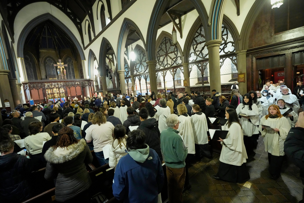 The choir enters St. Stephen's Church during a community service for the victims of the Brown University shooting, Tuesday, Dec. 16, 2025. (AP Photo/Robert F. Bukaty)