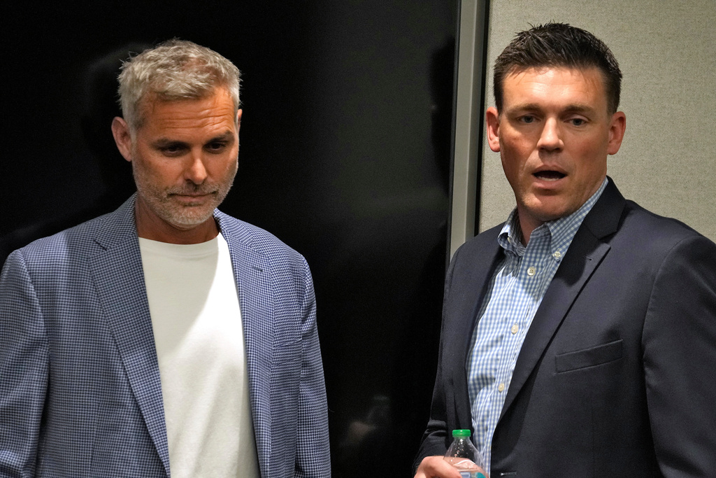 Tampa Bay Rays manager Kevin Cash, left, and Erik Neander, president of baseball operations, arrive before a news conference introducing the team's new owners, Tuesday, Oct. 7, 2025, in Tampa, Fla. (AP Photo/Chris O'Meara)