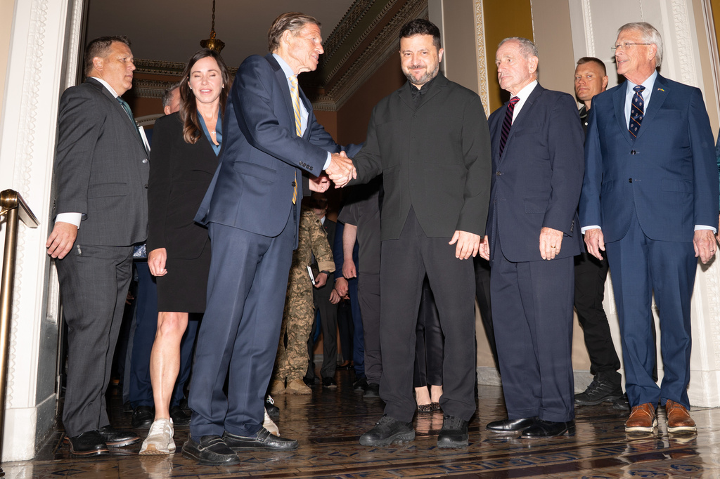 Ukraine's President Volodymyr Zelenskyy stands with a bipartisan group of Senators in the Capitol building, Tuesday, July 28, 2026, in Washington. (AP Photo/Allison Robbert)