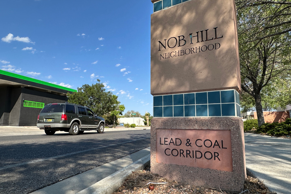 A vehicle heads down a corridor where stoplights are set for a specific speed limit as part of the "rest on red" signal program in Albuquerque, N.M., Wednesday, Aug. 12, 2026. (AP Photo/Susan Montoya Bryan)