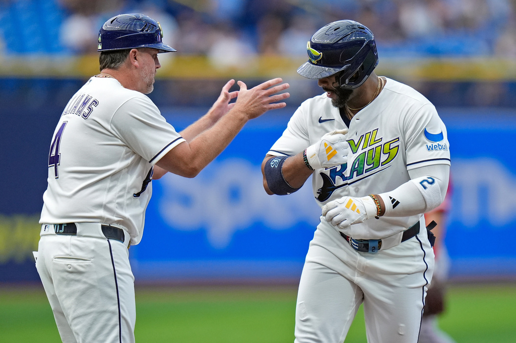 Tampa Bay Rays' Yandy Díaz celebrates his home run off Los Angeles Angels pitcher Walbert Ureña with third base coach Brady Williams (4) during the first inning of a baseball game Friday, May 29, 2026, in St. Petersburg, Fla. (AP Photo/Chris O'Meara)