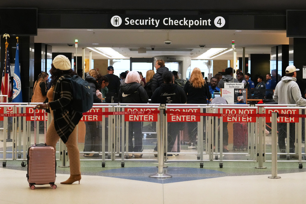 FILE - A traveler walks by a security checkpoint at Seattle-Tacoma International Airport, Nov. 6, 2025, in SeaTac, Wash. (AP Photo/Lindsey Wasson, File)
