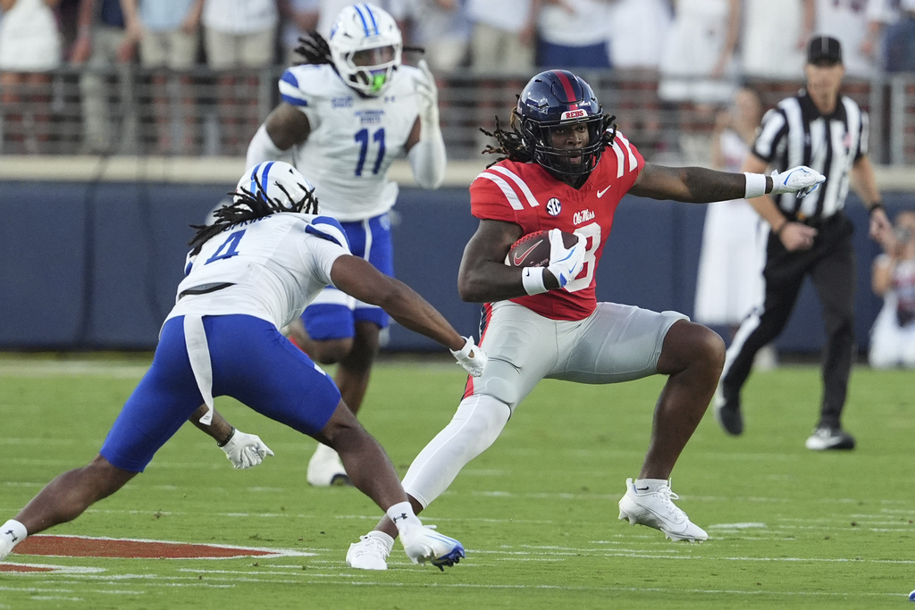 Mississippi tight end Dae'Quan Wright (8) dodges an attempt tackle by Georgia State safety D-Icey Hopkins (4) during the first half of an NCAA college football game in Oxford, Miss., Saturday, Aug. 30, 2025. (AP Photo/Rogelio V. Solis)