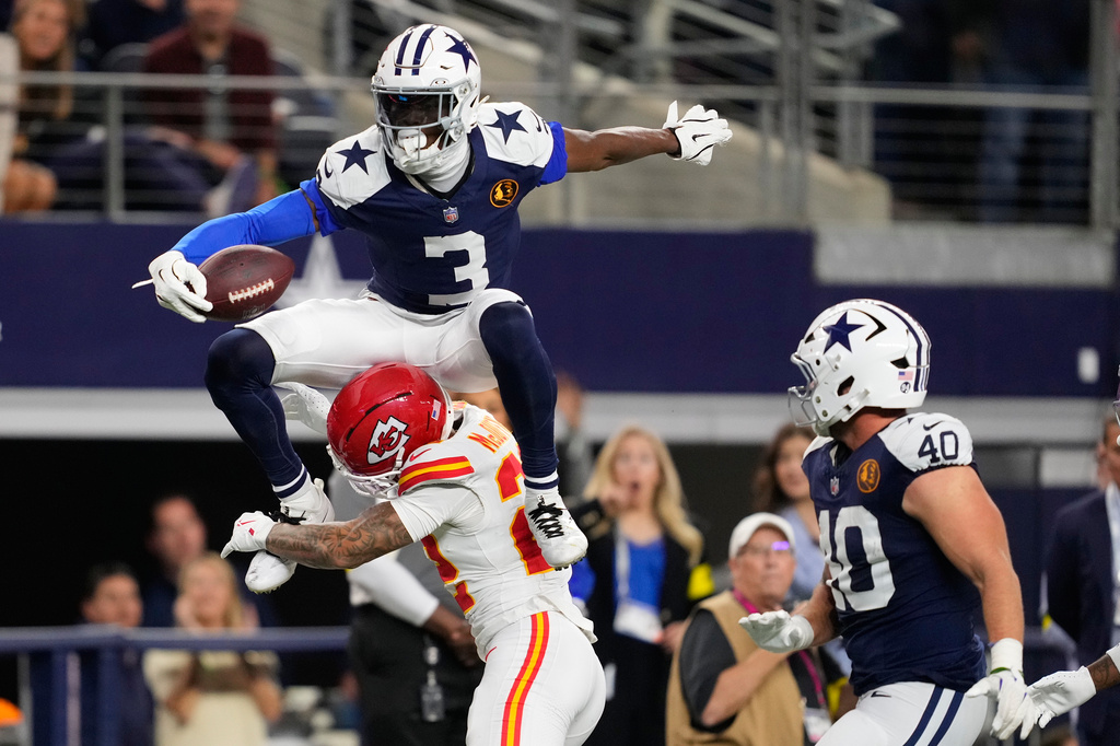 Dallas Cowboys wide receiver George Pickens (3) leaps over Kansas City Chiefs cornerback Trent McDuffie (22) during the second half of an NFL football game Thursday, Nov. 27, 2025, in Arlington, Texas. (AP Photo/Tony Gutierrez)