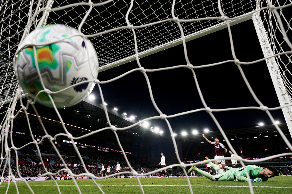 Liverpool goalkeeper Giorgi Mamardashvili is scored on by Aston Villa's John McGinn during the English Premier League soccer match between Aston Villa and Liverpool in Birmingham, England, Friday, May 15, 2026. (Jacob King/PA via AP)