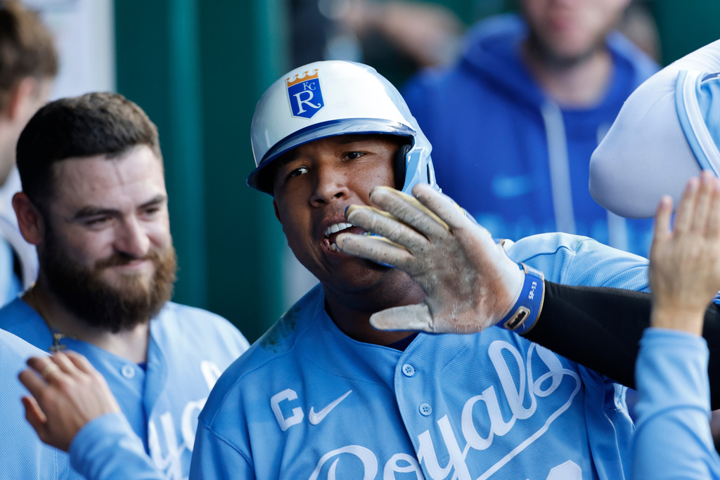 Kansas City Royals' Salvador Perez, center, celebrates in the dugout after hitting a home run as Kyle Isbel stands behind during the fourth inning of a baseball game in Kansas City, Mo., Saturday, Aug. 22, 2026. (AP Photo/Colin E. Braley)