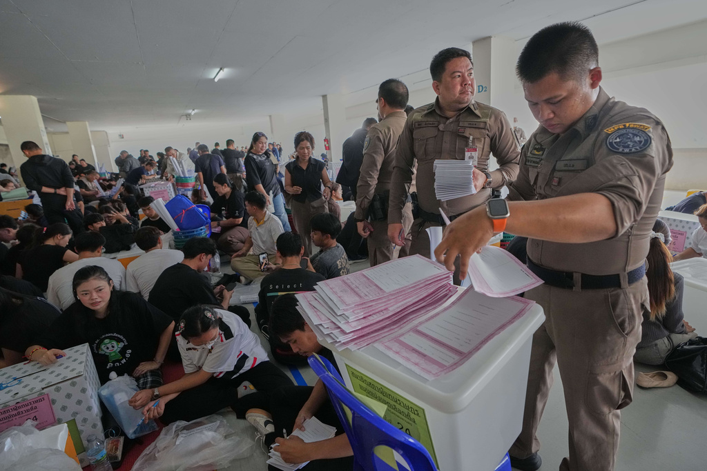 Police officers and Volunteers check ballots for Sunday's general election in Bangkok, Thailand, Saturday, Feb. 7, 2026. (AP Photo/Sakchai Lalit)