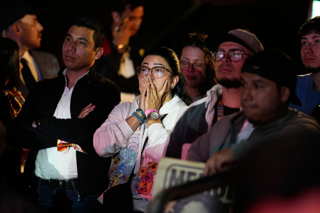 Supporters of presidential candidate Ivan Cepeda of the ruling Historic Pact coalition react to early election results after polls closed duuring the runoff election in Bogota, Colombia, Sunday, June 21, 2026. (AP Photo/Fernando Vergara)