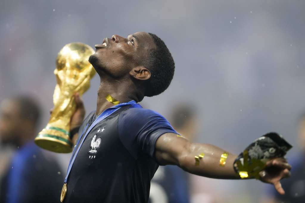 FILE - France's Paul Pogba celebrates with the trophy after the final match between France and Croatia at the 2018 soccer World Cup in the Luzhniki Stadium in Moscow, Russia, July 15, 2018. (AP Photo/Natacha Pisarenko, file)