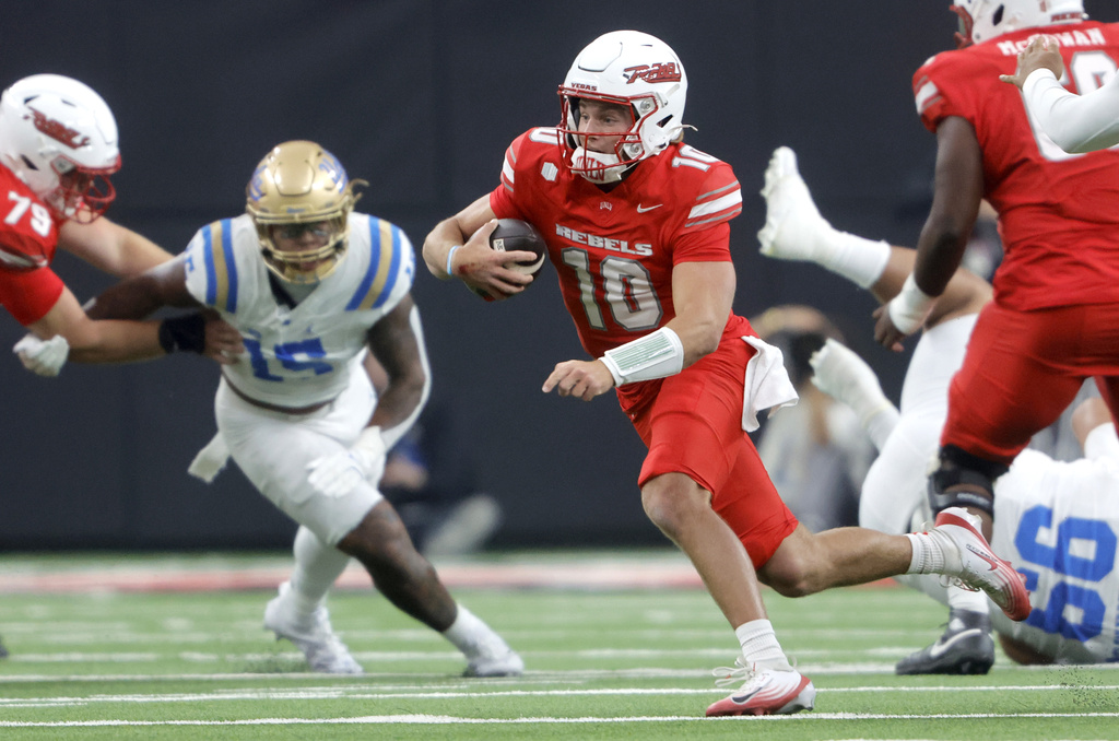 UNLV quarterback Anthony Colandrea (10) keeps the football during the first half of an NCAA football game against UCLA Saturday, Sept. 6, 2025, in Las Vegas. (Steve Marcus/Las Vegas Sun via AP)