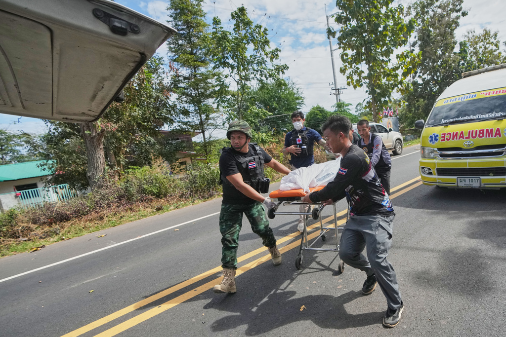 Thai rescue team members move a body into a vehicle after a Cambodian artillery strike in Sisaket province, Sunday, Dec. 14, 2025. (AP Photo/Sakchai Lalit)