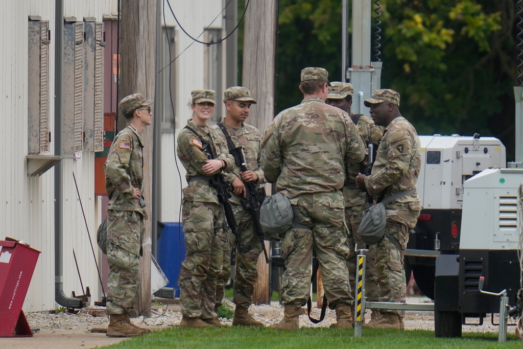 Military personnel in uniform, with the Texas National Guard patch on, are seen at the U.S. Army Reserve Center, Tuesday, Oct. 7, 2025, in Elwood, Ill., a suburb of Chicago. (AP Photo/Erin Hooley)