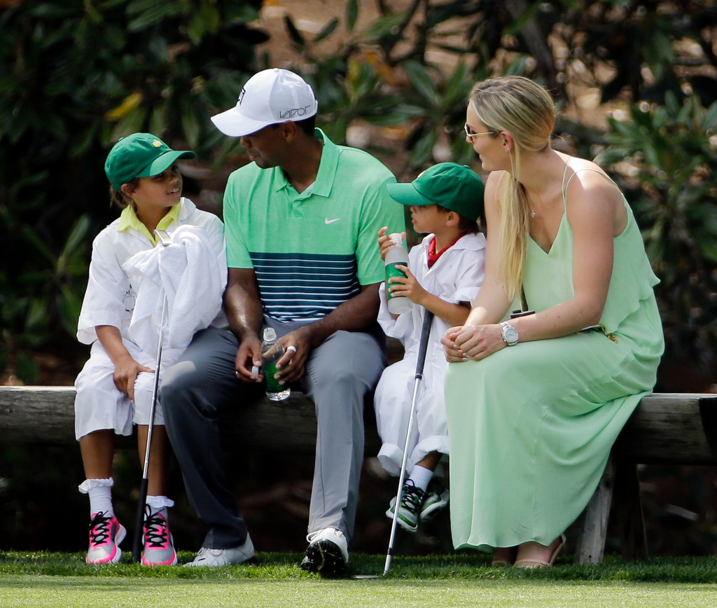 FILE - Lindsey Vonn sits with Tiger Woods with his children Sam and Charlie during the Par 3 contest at the Masters golf tournament, April 8, 2015, in Augusta, Ga. (AP Photo/David J. Phillip, File)