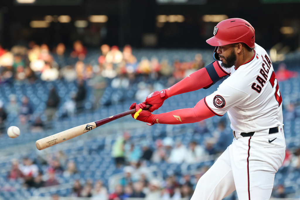 Washington Nationals' Luis García Jr. hits a single against Atlanta Braves pitcher Reynaldo López during the first inning of a baseball game, Tuesday, April 21, 2026, in Washington. (AP Photo/Terrance Williams)