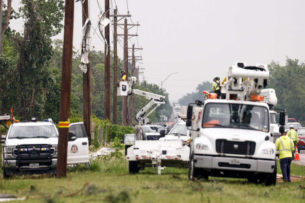 Tri-County Electric Cooperative linemen work to restore power after severe weather passed through the area, Sunday, April 26, 2026, in Springtown, Texas. (Elías Valverde II/The Dallas Morning News via AP)
