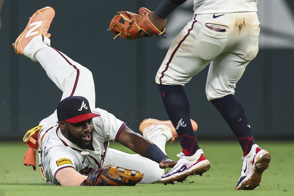 Atlanta Braves outfielder Michael Harris II makes a sliding catch in the ninth inning of a baseball game against the Chicago White Sox, Tuesday, Aug. 19, 2025, in Atlanta. (AP Photo/Colin Hubbard)