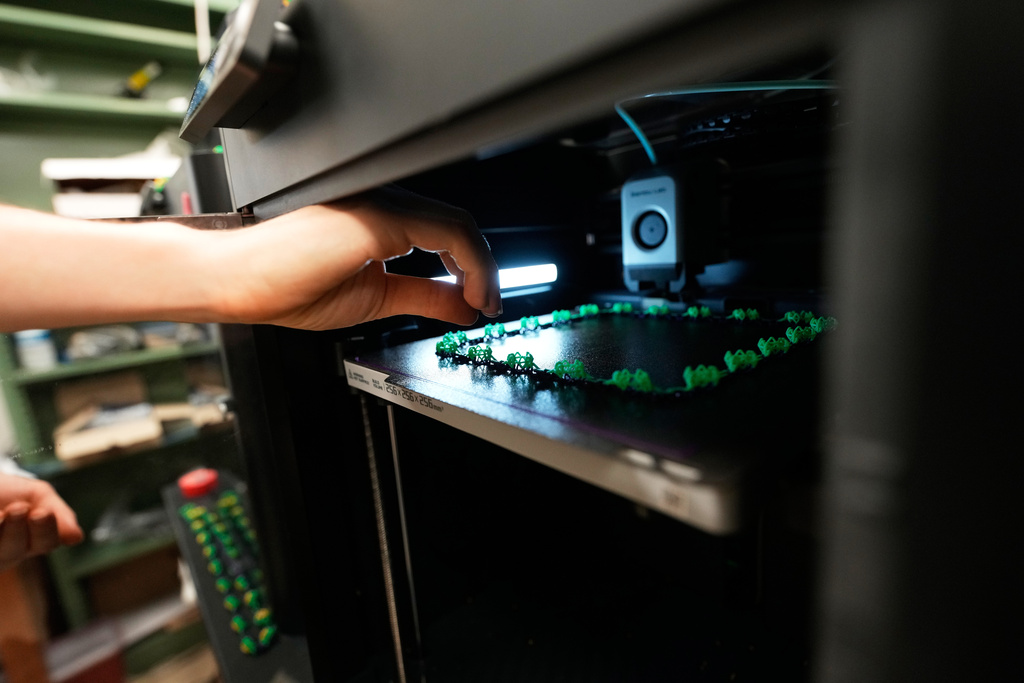 Alexis Strain, graduate student in biological sciences at Louisiana State University shows A 3D printer they are using to create biodegradable Mardi Gras beads, Jan. 27, 2026, in Baton Rouge, La. (AP Photo/Gerald Herbert)