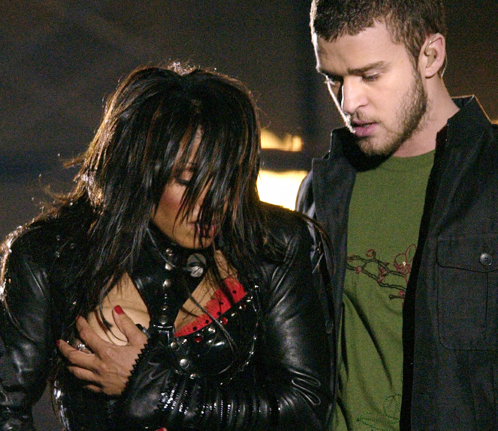 FILE - Janet Jackson, left, covers her breast after a wardrobe malfunction during the halftime performance with Justin Timberlake at Super Bowl XXXVIII in Houston on Feb. 1, 2004. (AP Photo/David Phillip, File)