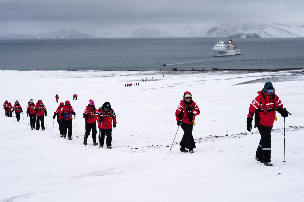 FILE - Passengers walk inside the volcano at Deception Island in Antarctica, Wednesday, Nov. 26, 2025. (AP Photo/Mark Baker, File)