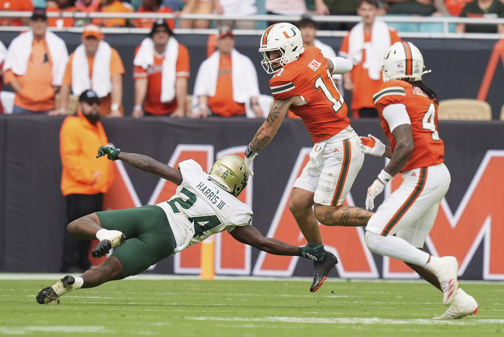 South Florida linebacker Mac Harris tackles Miami quarterback Carson Beck as he scrambles with the ball during the first half of an NCAA college football game, Saturday, Sept. 13, 2025, in Miami Gardens, Fla. (AP Photo/Rebecca Blackwell)