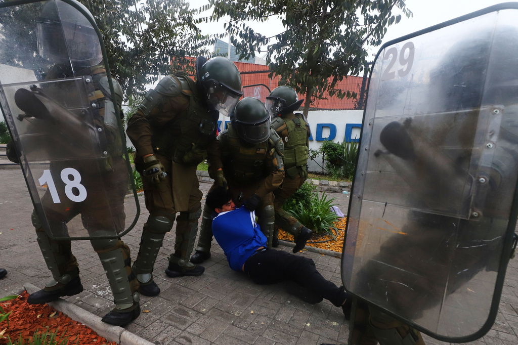 FILE - Police detain a demonstrator during the May Day protest in Santiago, Chile, May 1, 2026. (AP Photo/Luis Hidalgo, File)