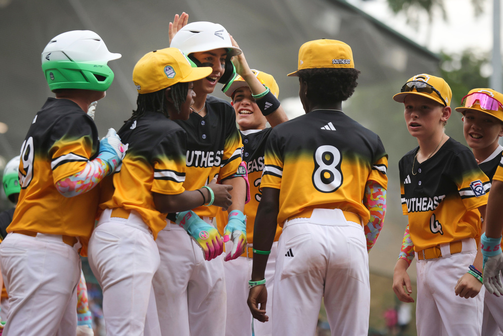 Irmo, S.C.'s Joe Giulietti, center, is greeted by teammates after hitting a home run against Braintree, Mass., during the second inning of a baseball game at the Little League World Series, Thursday, Aug. 14, 2025, in South Williamsport, Pa. (AP Photo/Jared Freed)