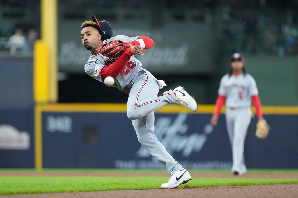 Washington Nationals' Nasim Nuñez throws to first base during the fourth inning of a baseball game against the Milwaukee Brewers, Sunday, April 12, 2026, in Milwaukee. (AP Photo/Aaron Gash)