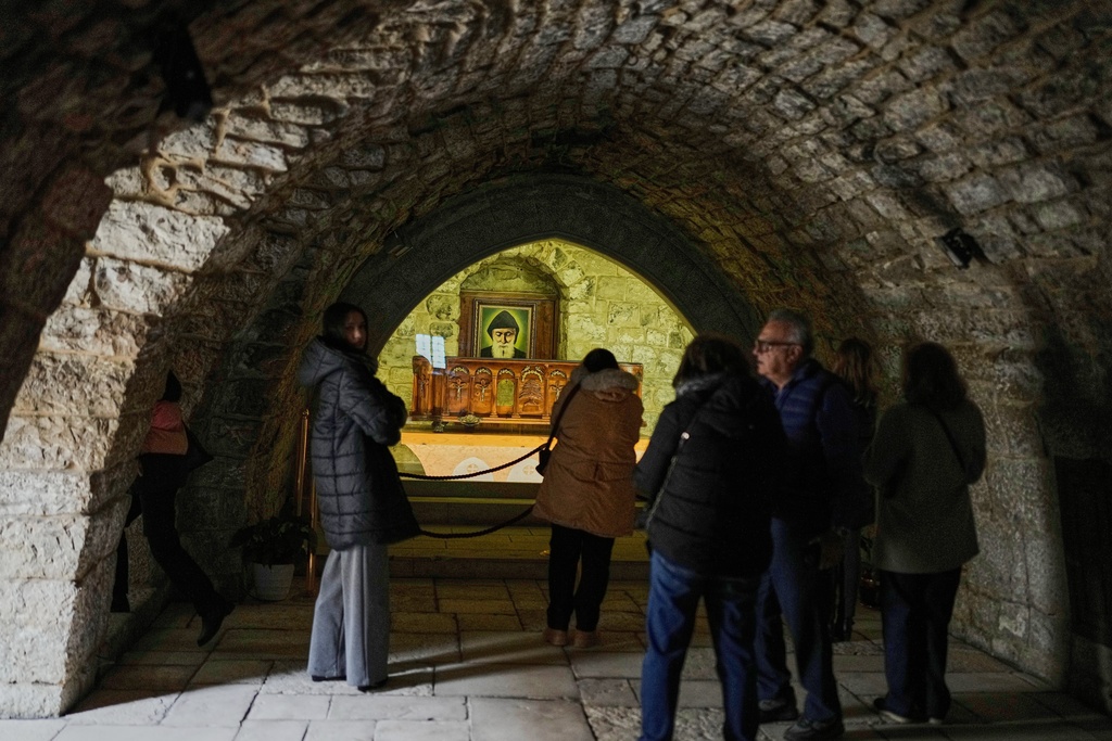 Pilgrims visit the tomb of St. Charbel inside the monastery in the northern village of Annaya, Lebanon, Saturday, Nov. 15, 2025. (AP Photo/Hassan Ammar)