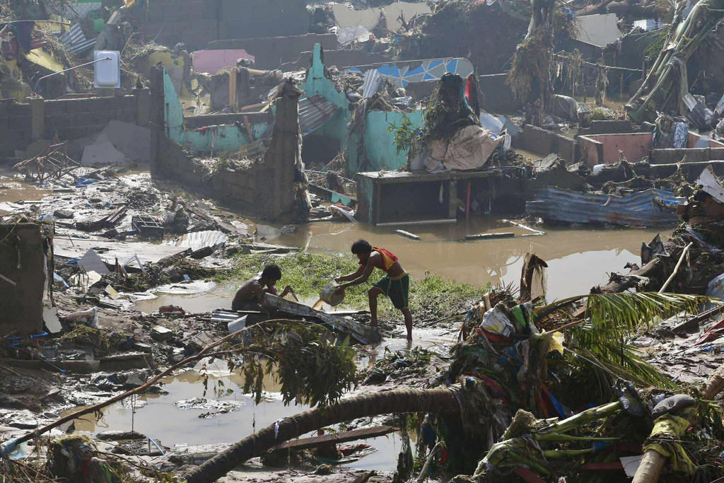 Residents try to salvage personal belongings as they return to their damaged homes after Typhoon Kalmaegi caused devastation in communities along the Mananga River in Talisay City, Cebu province, central Philippines, Wednesday, Nov. 5, 2025. (AP Photo/Jacqueline Hernandez)