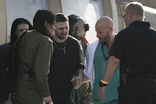 Elkana Bohbot, an Israeli hostage released from the Gaza Strip waves walks off a helicopter at the Sheba Medical Center in Ramat Gan, Israel, Monday, Oct. 13, 2025. (AP Photo/Leo Correa) Elkana Bohbot, an Israeli hostage released from the Gaza Strip waves walks off a helicopter at the Sheba Medical Center in Ramat Gan, Israel, Monday, Oct. 13, 2025. (AP Photo/Leo Correa)