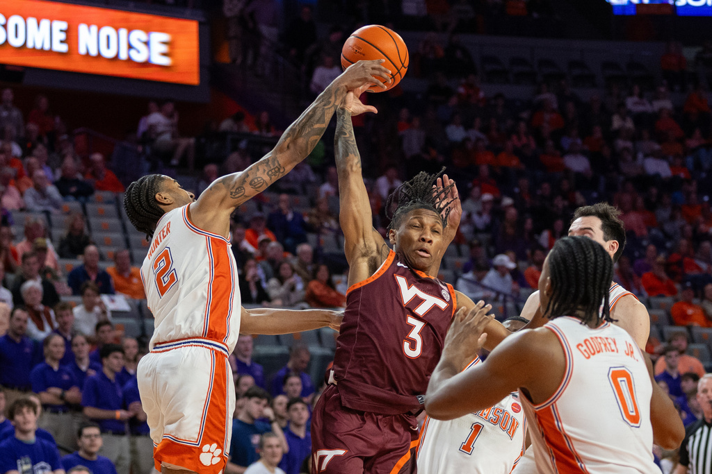 Clemson guard Dillon Hunter (2) knock the pass away from Virginia Tech guard Ben Hammond (3) during the first half of an NCAA college basketball game Wednesday, Feb. 11, 2026, in Clemson, S.C. (AP Photo/Scott Kinser)
