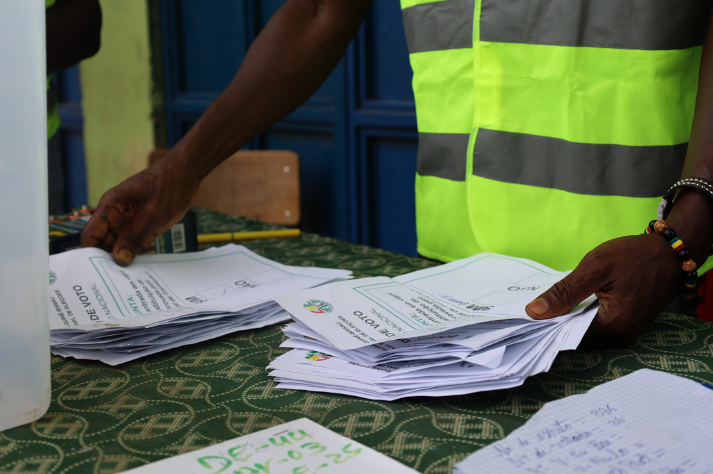 Election officials sort through ballots during a referendum on granting new presidential powers in Bissau, Guinea Bissau, Sunday, Aug. 30, 2026. (AP Photo/Darcicio Barbosa)