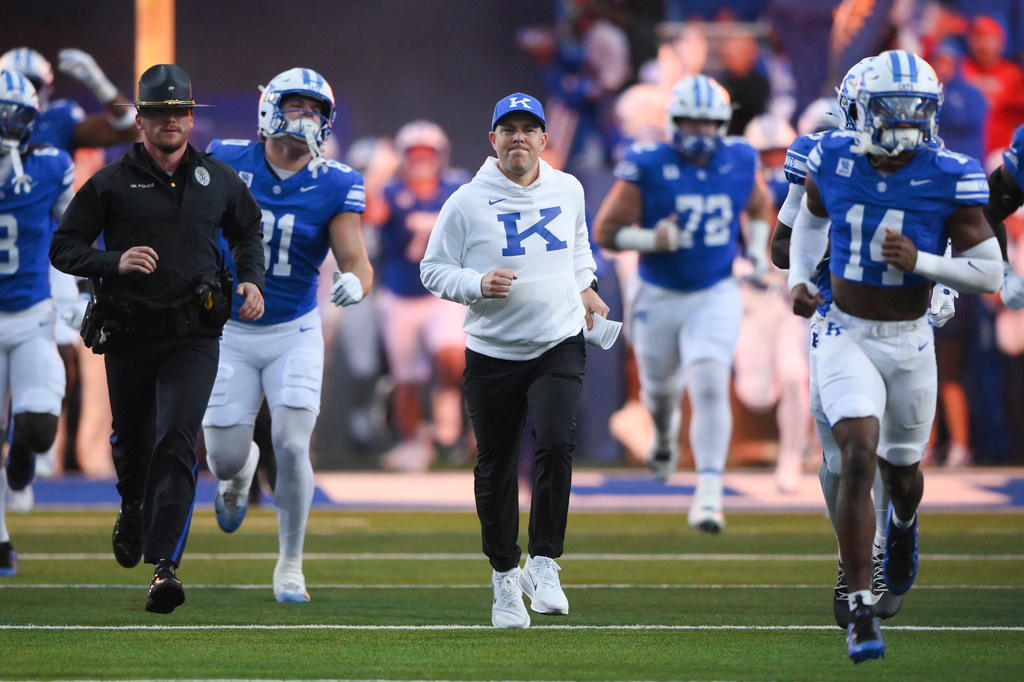 Kentucky head coach Will Stein, center, takes the field before an NCAA college football game against LSU, Saturday, Oct. 10, 2026, in Lexington, Ky. (AP Photo/Tanner Pearson)