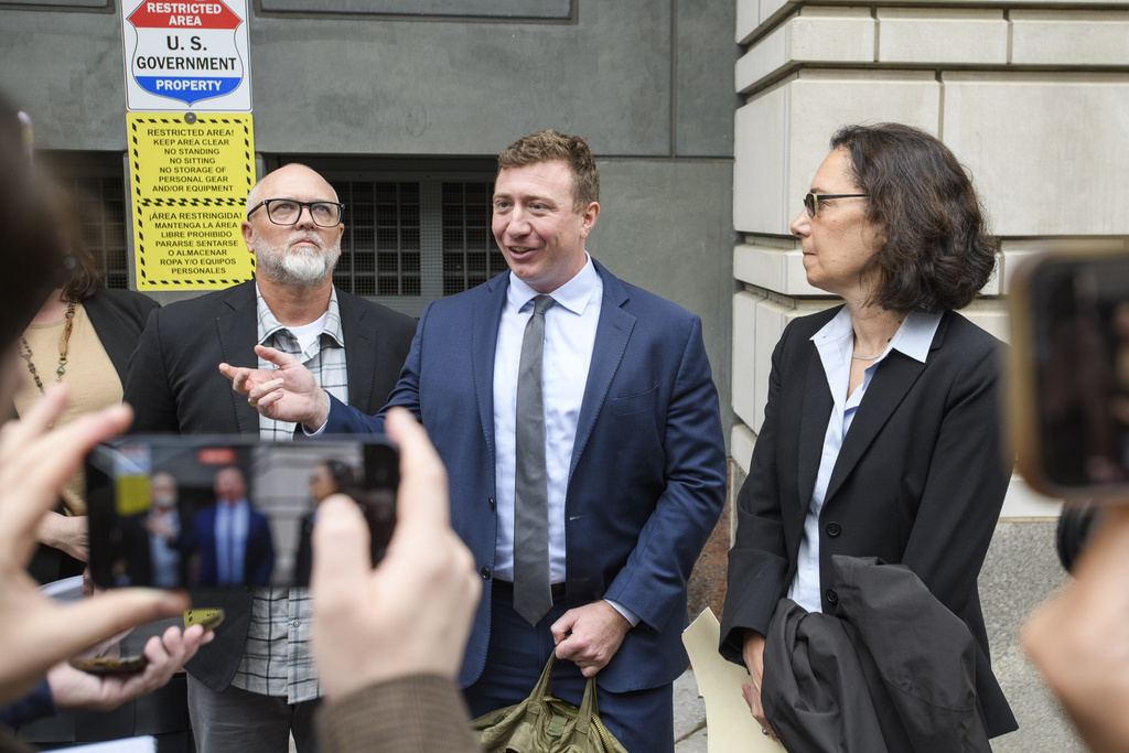 Jan Carey, left, a North Carolina veteran who burned a flag near the White House last month, listens while his attorneys Nick Place, center, and Mara Verheyden-Hilliard, right, speak following his arraignment at the E. Barrett Prettyman Federal Courthouse, Wednesday, Sept. 17, 2025, in Washington. (AP Photo/Rod Lamkey, Jr.)