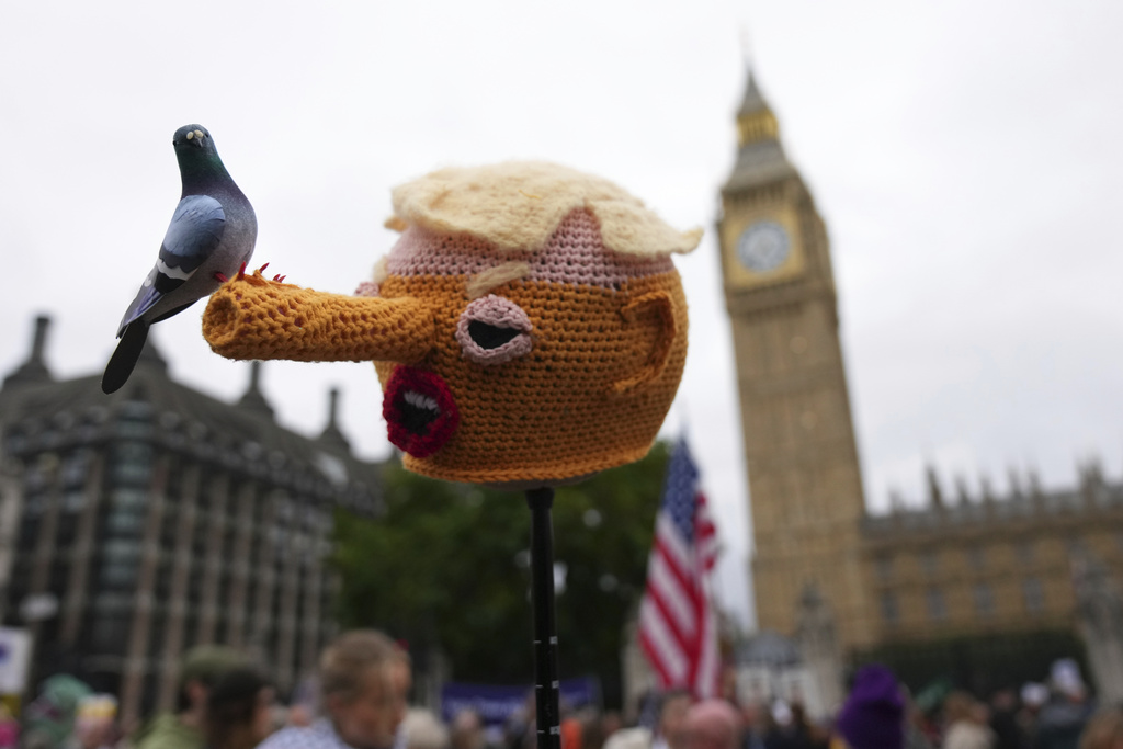A protester holds an orange Pinocchio head during a demonstration of the Stop Trump Coalition group against President Donald Trump's state visit in London, Wednesday, Sept. 17, 2025.(AP Photo/Joanna Chan)