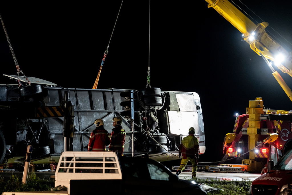 Emergency responders recover a travel coach after an accident in Susch in the canton of Grisons, Switzerland, on Friday, Sept. 11, 2026. (Claudio Thoma/Keystone via AP)