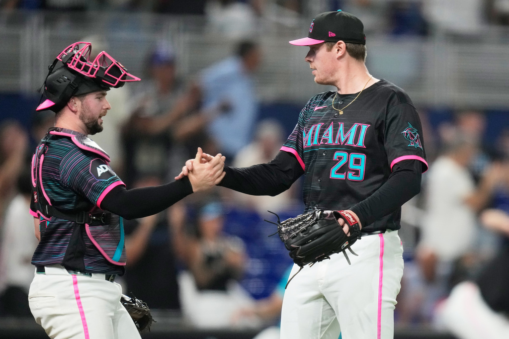 Miami Marlins relief pitcher Pete Fairbanks (29) shakes hands with catcher Joe Mack, left, after the Marlins defeated the San Francisco Giants during a baseball game, Friday, June 19, 2026, in Miami. (AP Photo/Lynne Sladky)