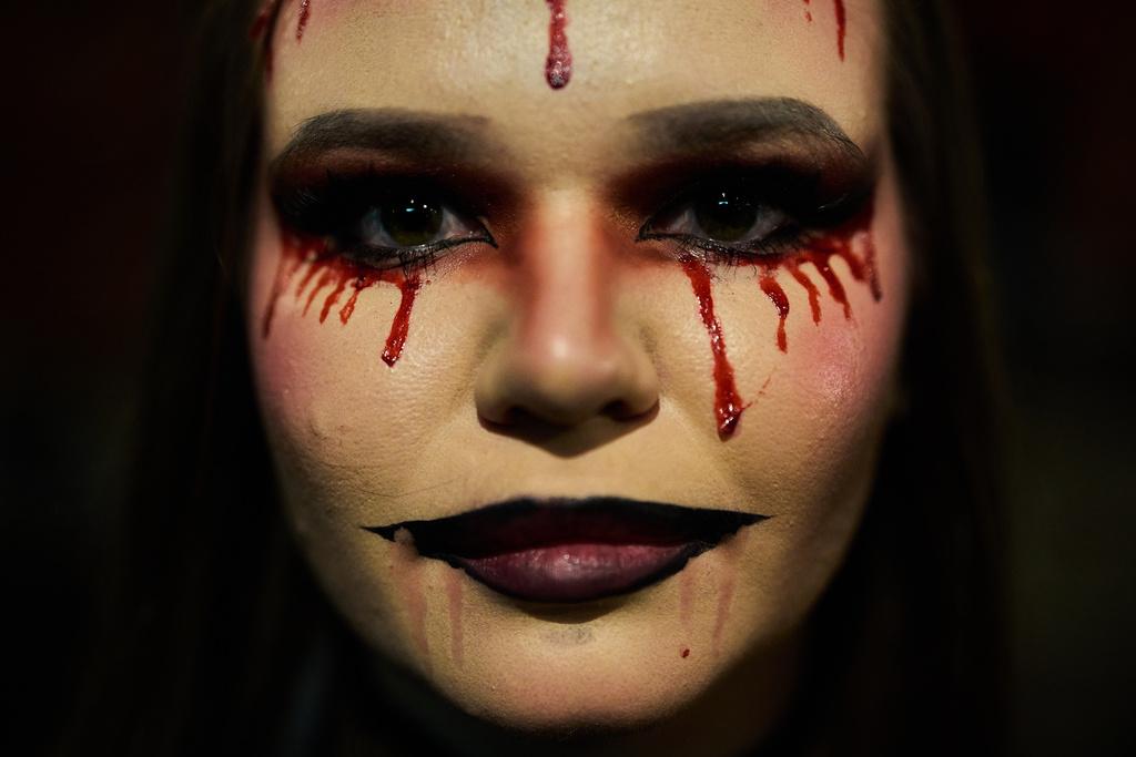 A girl dressed up in scary costume takes part in a Halloween party in Berlin, Friday, Oct. 31, 2025. (AP Photo/Ebrahim Noroozi)